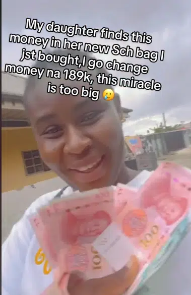 Woman overjoyed as she finds Chinese Yuan worth N200K in child’s new school bag (Video)